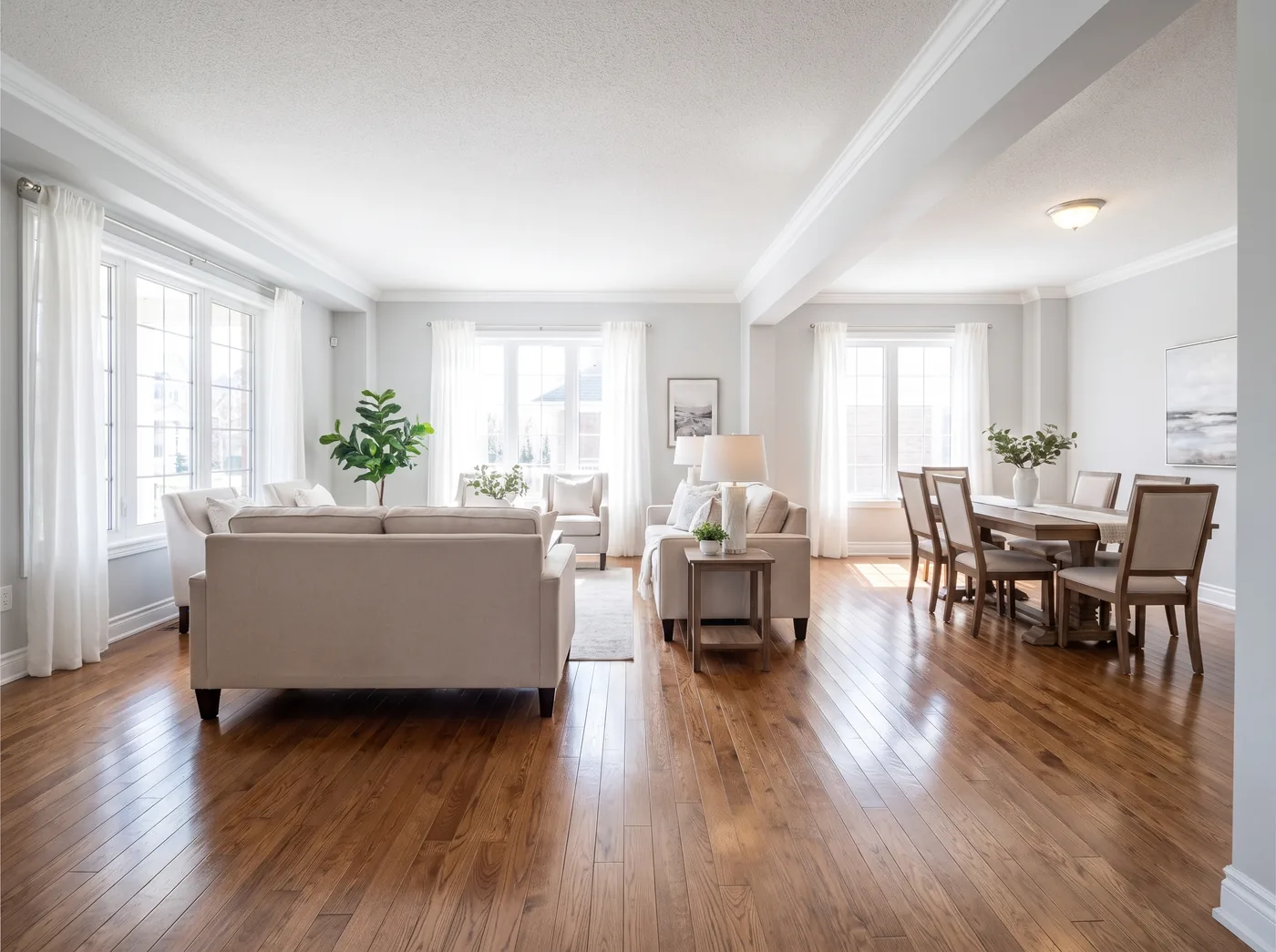Staged living and dining room with gleaming refinished oak hardwood floors